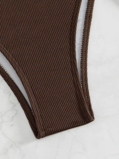 Black ribbed two-piece bikini with an underwire top and tie-side bottoms on a white marble surface. - Image 21