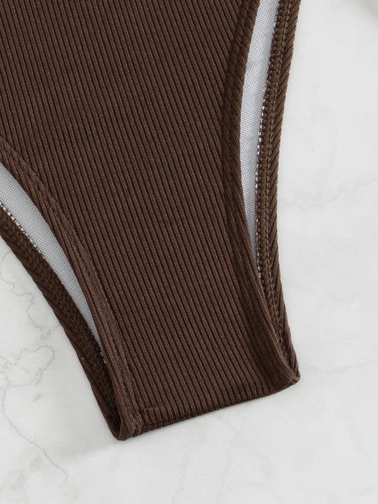 Black ribbed two-piece bikini with an underwire top and tie-side bottoms on a white marble surface. - Image 21