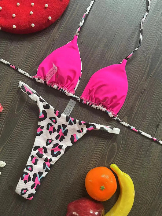 White textured bikini with red cherry print, featuring a triangle top and tie-side bottoms, on a woven mat. - Image 9