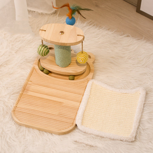 White cat playing with a wooden multi-level track toy featuring a spring-mounted yellow feather ball and a green catnip ball. - Image 24