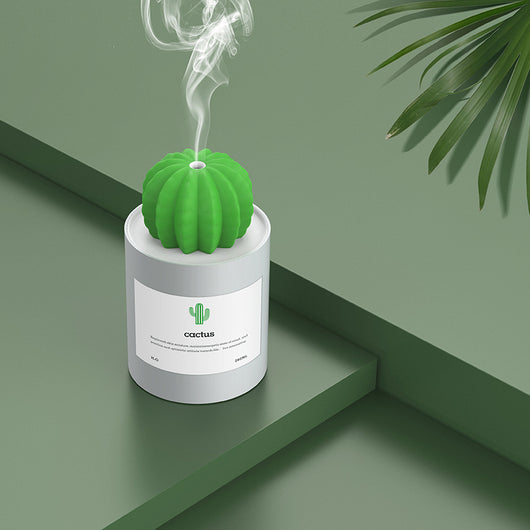 Person holding a glowing white cactus humidifier with a green top; inset shows five white humidifier filter sticks. - Image 5