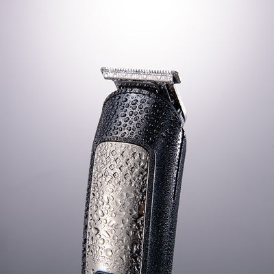 Five-in-one HTC electric hair clipper set with multiple attachments and a black charging stand on a dark background. - Image 3