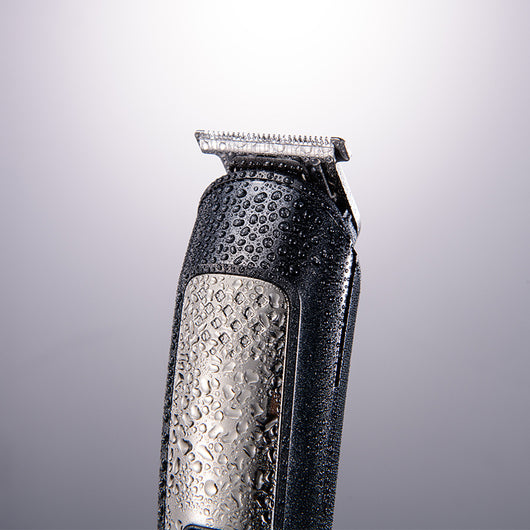 Five-in-one HTC electric hair clipper set with multiple attachments and a black charging stand on a dark background. - Image 3