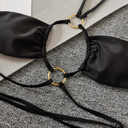 Solid black two-piece swimsuit set with a bandeau top, gold-tone O-rings, and tie straps, paired with matching thong bottoms. - Image 8