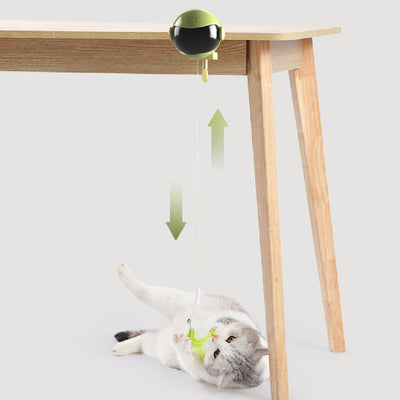Automatic lifting cat toy with a yellow ball and white clamp, featuring interchangeable feather and pom-pom attachments.