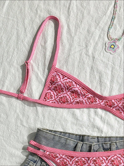 Black bandeau bikini swimsuit with thin straps and a gold-toned abstract ring detail on the top, paired with matching string bottoms. - Image 23
