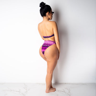 Woman in a purple and pink snakeskin print three-piece swimsuit with an off-shoulder crop top and high-waisted bottoms. - Image 15