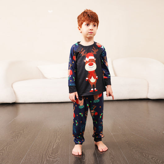 Family Christmas pajamas with a cartoon reindeer wearing a Santa hat and red scarf on a black top, and dark blue pants with a repeating reindeer and holly patte - Image 11