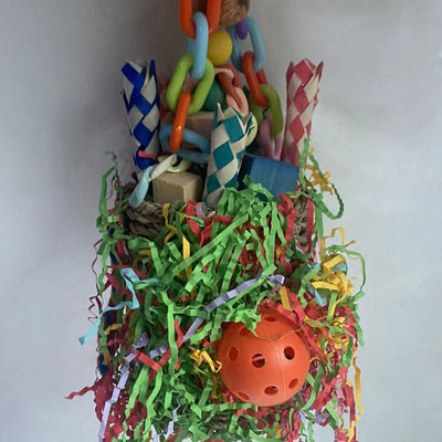 Colorful hanging bird toy with a woven grass basket, wooden beads, paper tubes, and shredded paper for parrots. - Image 2