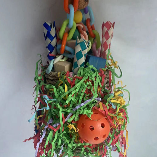 Colorful hanging bird toy with a woven grass basket, wooden beads, paper tubes, and shredded paper for parrots. - Image 2