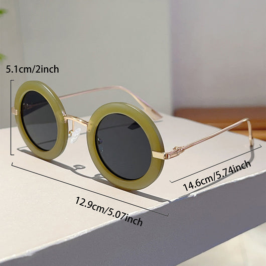 Small frame oval fashion sunglasses with black frames and vibrant orange lenses, held by a hand. - Image 14
