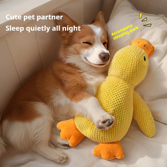 Yellow plush duck dog toy with ribbed texture, orange beak and feet, and black eyes, measuring 25cm long.