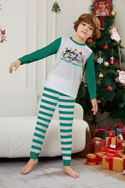 Family of four wearing matching green and white striped Christmas pajamas with "Merry Christmas" graphic. - Image 12