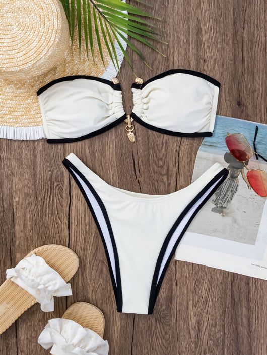 Women's white and black color-contrast tube top bikini with gold-tone hardware, modeled by a pool. - Image 16