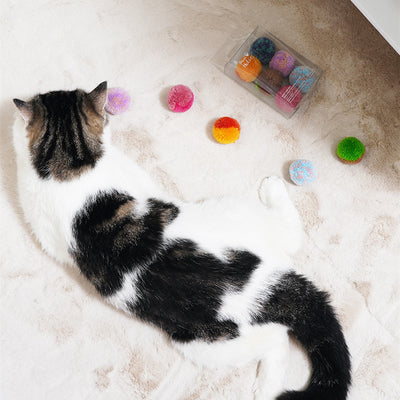 Two fluffy cat pom-pom toys, one pink and blue, one pink, in a clear box with a small bottle of catnip hydrosol. - Image 4