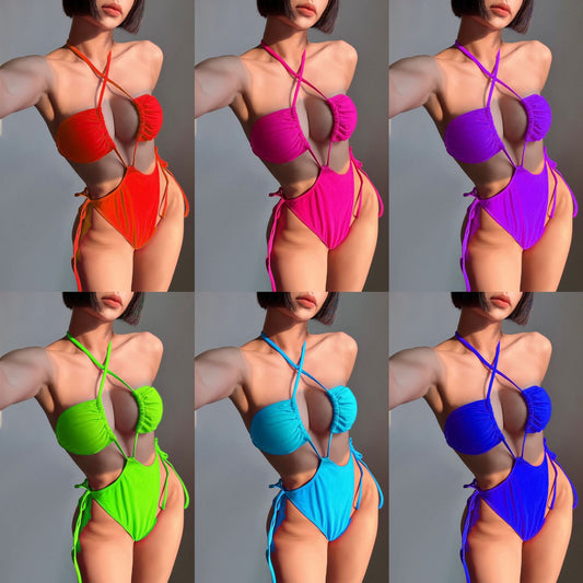 Black drawstring one-piece swimsuit with a ruched halter top and high-cut, tie-side bottom on a woman. - Image 2
