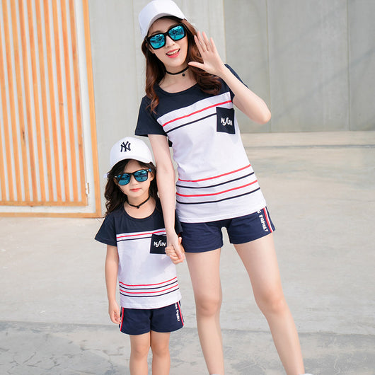 Navy blue children's shorts with white ribbed waistband, beige drawstring, and side pockets. Features red, white, and black side stripes and "LOVING FAMILY" tex - Image 9