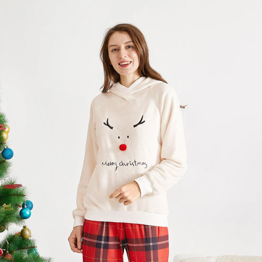 Family of four wearing matching cream fleece reindeer pajamas with red plaid pants, posing for a Christmas photo. - Image 2