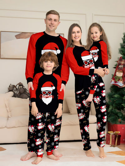 Woman wearing a black and red Christmas pajama set with a Santa Claus graphic top and snowman-patterned pants. - Image 6
