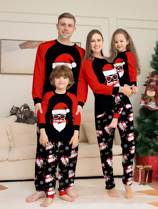 Woman wearing a black and red Christmas pajama set with a Santa Claus graphic top and snowman-patterned pants. - Image 6
