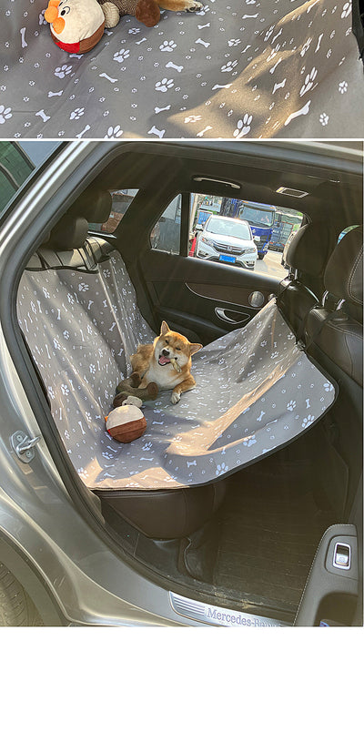 Pink car pet mat with white paw print and bone patterns, featuring black straps for securing to a rear seat. - Image 33