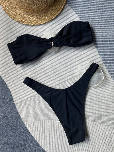 Black tube top bikini with white three-dimensional flower embellishments, worn by a woman partially submerged in water. - Image 21