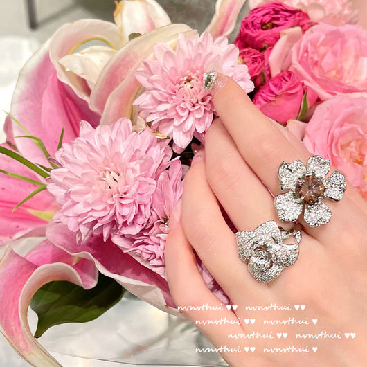 Pair of sparkling rose-shaped stud earrings, encrusted with clear gemstones, displayed in a brown jewelry box. - Image 10