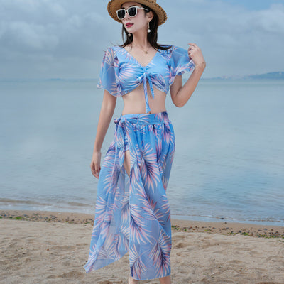 Women's light blue tropical leaf print three-piece swimsuit with short sleeve bikini top, bottoms, and sarong skirt. - Image 18