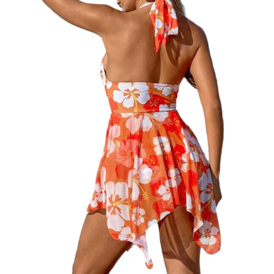 Women's orange and white floral print one-piece swimsuit with a halter neck and a flowing skirted bottom on a beach. - Image 5