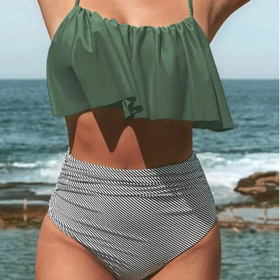 Women's black ruffled tankini swim top with adjustable straps and high-waisted black and white striped swim bottoms.