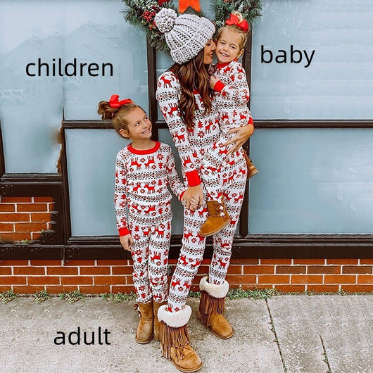 Mother and two daughters in matching red and white reindeer and snowflake print long-sleeve Christmas pajamas. - Image 13