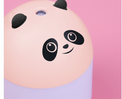 Panda-shaped humidifier and aromatherapy machine emitting mist, glowing red, held in a hand. - Image 6