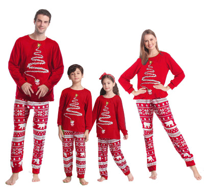 Family of four wearing matching red Christmas pajamas with white Christmas tree tops and polar bear print pants. - Image 3