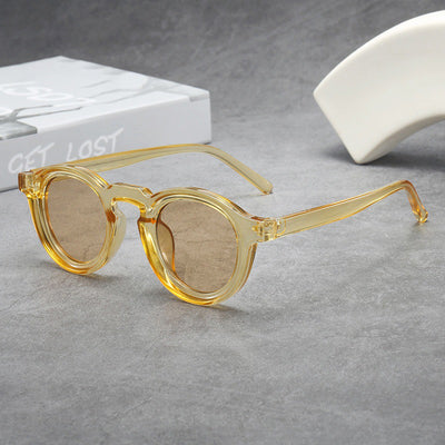 Vintage round frame sunglasses with black frames and pink lenses on a gray surface. - Image 8