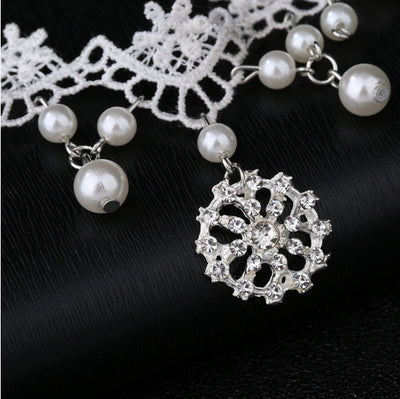 White lace choker necklace with dangling faux pearls and a central rhinestone pendant on a black jewelry bust. - Image 8