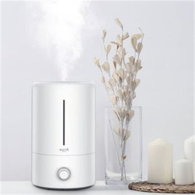 White cylindrical air aroma diffuser with a vertical water level indicator and a control knob on the front. - Image 10