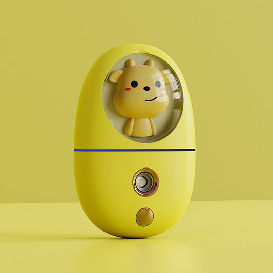 White egg-shaped portable facial humidifier with a pink cartoon rabbit inside a clear dome, gold nozzle and button. - Image 2