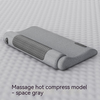 Dark gray cervical spine pillow with light gray textured massage area and power button on a light gray surface. - Image 8