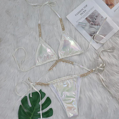 Iridescent purple and pink two-piece bikini with gold-toned crystal embellishments on a white faux fur background. - Image 6
