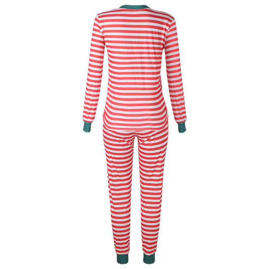 Family of four wearing matching red and white striped Christmas pajamas with green cuffs. One child wears a Santa hat, another wears reindeer antlers. - Image 17