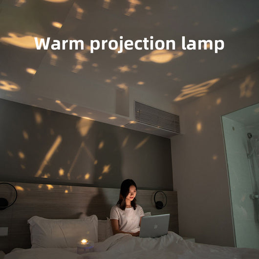 White portable projection humidifier with a translucent water tank and gold-accented control buttons. - Image 6