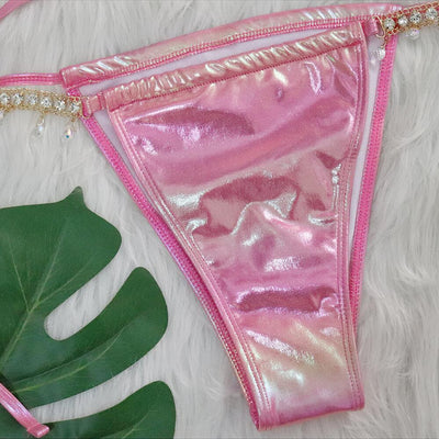 Iridescent purple and pink two-piece bikini with gold-toned crystal embellishments on a white faux fur background. - Image 29