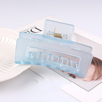 Frosted light blue rectangular hair claw clip with a gold-toned spring mechanism, ideal for securing hair. - Image 16