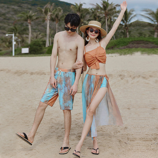 Men's or unisex swim shorts with a blue, orange, and brown abstract tie-dye print, featuring a drawstring waist and side pockets. - Image 2