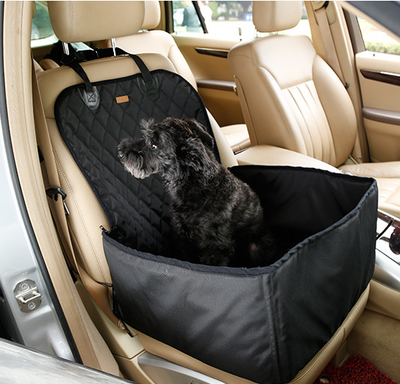 Black quilted waterproof pet seat cover and booster pad installed in a beige car, with a black dog sitting on it. - Image 2