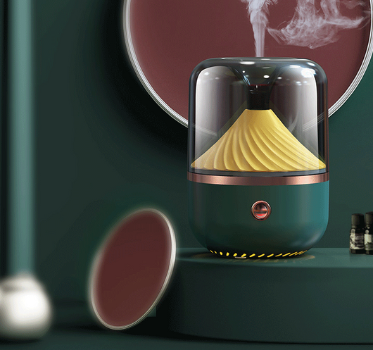 Dark green aromatherapy machine with a transparent top, yellow spiral diffuser, and copper trim. - Image 5