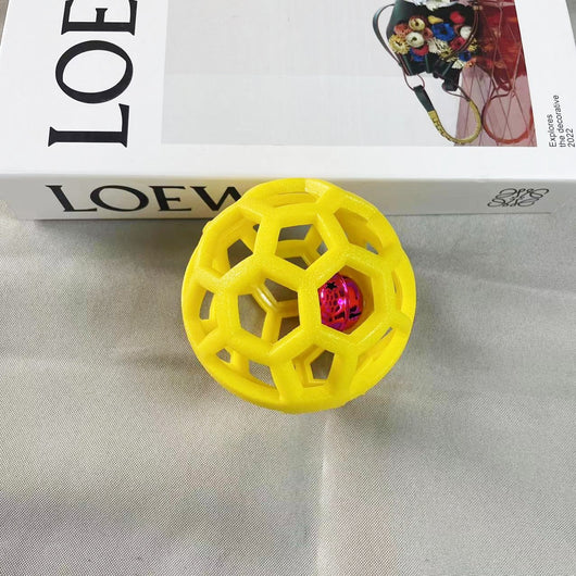 Orange TPR hollow lattice dog chew ball with a shiny pink bell ball inside for interactive pet play. - Image 7