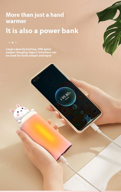 Dark green paw-shaped hand warmer and power bank with a cute bear design, held in a hand with white faux fur gloves. - Image 20