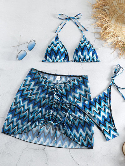Three-piece printed swimsuit with a red and teal abstract pattern, featuring a halter bikini top, bottom, and mesh wrap skirt with drawstring. - Image 5