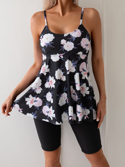 Women's navy blue two-piece swimsuit with white floral tankini top and matching solid swim shorts. - Image 9